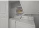 Convenient laundry room featuring shelving above the washer and dryer at 15 Gray Fox Ct, Durham, NC 27713