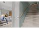 Hallway entrance into a living room and stairs with a light wood railing at 15 Gray Fox Ct, Durham, NC 27713