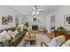Bright living room featuring a fireplace, ceiling fan, wood floors, and stylish decor at 15 Gray Fox Ct, Durham, NC 27713