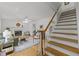 Cozy living room and stairs featuring a fireplace and hardwood flooring at 15 Gray Fox Ct, Durham, NC 27713