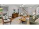 Comfortable living room with hardwood floors, white trim, and view to stairway and front door at 15 Gray Fox Ct, Durham, NC 27713
