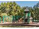 Community playground features climbing structures, slides, and play areas set amidst mature trees at 15 Gray Fox Ct, Durham, NC 27713