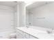 Bright bathroom with double vanity sinks, large mirror and a shower-tub combination at 157 Vaughan Farms Drive Dr, Angier, NC 27501