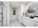 Elegant bathroom featuring a double vanity, framed mirrors, and sleek, glass enclosed shower at 157 Vaughan Farms Drive Dr, Angier, NC 27501