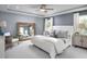 Serene primary bedroom with a tray ceiling, large mirror and soft, neutral tones at 157 Vaughan Farms Drive Dr, Angier, NC 27501