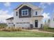 Charming two-story home featuring a brick walkway and a three-car garage, perfect for a growing Gathering at 157 Vaughan Farms Drive Dr, Angier, NC 27501