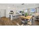 Open-concept kitchen featuring a large island, modern appliances, and seamless access to the dining area at 157 Vaughan Farms Drive Dr, Angier, NC 27501
