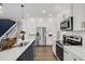 Contemporary kitchen featuring stainless steel appliances, white cabinetry, and a stylish blue island at 157 Vaughan Farms Drive Dr, Angier, NC 27501