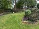 Spacious backyard with a green lawn, mature trees, and a wooden fence, offering a private outdoor space at 1615 Bickett Blvd, Raleigh, NC 27608