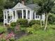 Charming cottage-style home featuring a welcoming front porch, well-manicured landscaping, and classic architectural details at 1615 Bickett Blvd, Raleigh, NC 27608