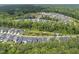 High-angle aerial view showcasing the community's dense tree coverage and serene ponds at 167 Monteith Dr, Chapel Hill, NC 27516