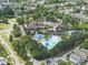 Birds-eye view highlighting the community pool and clubhouse surrounded by mature trees at 167 Monteith Dr, Chapel Hill, NC 27516