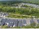 Aerial view showcases the neighborhood's layout surrounded by lush green space and serene ponds at 167 Monteith Dr, Chapel Hill, NC 27516