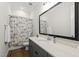 Well-lit bathroom with a wide mirror and a vanity with a sink and chrome fixtures at 167 Monteith Dr, Chapel Hill, NC 27516