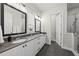 Modern bathroom with double sinks, elegant mirrors, and tiled floors at 167 Monteith Dr, Chapel Hill, NC 27516
