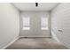 Empty bedroom featuring two windows, carpet, neutral walls, and a ceiling fan at 167 Monteith Dr, Chapel Hill, NC 27516