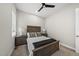 Bedroom featuring ceiling fan, neutral walls, carpet, and a wooden queen bed with side tables at 167 Monteith Dr, Chapel Hill, NC 27516