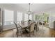 Bright dining room features stylish chandelier, wood floors, and access to outdoor patio at 167 Monteith Dr, Chapel Hill, NC 27516