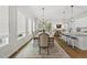 Bright dining area boasts an open floorplan, modern lighting, and access to a back patio at 167 Monteith Dr, Chapel Hill, NC 27516