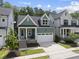 Charming two-story home featuring a neatly manicured lawn and an attached two-car garage at 167 Monteith Dr, Chapel Hill, NC 27516