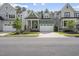 Inviting two-story home showcasing a lush green lawn, classic design, and a two-car garage at 167 Monteith Dr, Chapel Hill, NC 27516