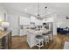Modern kitchen boasts white cabinets, granite countertops, stainless appliances, and stylish pendant lights at 167 Monteith Dr, Chapel Hill, NC 27516