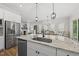 Bright kitchen with granite countertops, stainless appliances, and views into the dining and living rooms at 167 Monteith Dr, Chapel Hill, NC 27516