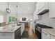 Open concept kitchen features granite countertops, stainless steel appliances, and view into the dining area at 167 Monteith Dr, Chapel Hill, NC 27516