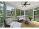 Cozy screened porch with comfortable seating, a ceiling fan, and views of the lush backyard at 167 Monteith Dr, Chapel Hill, NC 27516