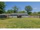 Exterior shot of backyard featuring patio area, storage shed, and large grass lawn at 169 Forest Dr, Graham, NC 27253