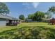 Private backyard with a gazebo, play area, storage shed, and lush lawn at 169 Forest Dr, Graham, NC 27253