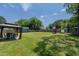 Large backyard featuring a gazebo, shed, playset, and well-maintained lawn at 169 Forest Dr, Graham, NC 27253