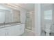 Bright bathroom with dual vanity, granite counters, glass shower, and a toilet at 169 Forest Dr, Graham, NC 27253