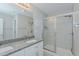 Bright bathroom with dual vanity, granite counters, and a glass-enclosed shower at 169 Forest Dr, Graham, NC 27253