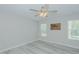 Neutral bedroom featuring hard surface floors, modern windows, and a ceiling fan at 169 Forest Dr, Graham, NC 27253