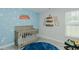 Charming Bedroom with a crib, a playful Toy Story-themed wall, and wood laminate flooring at 169 Forest Dr, Graham, NC 27253