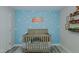 Adorable Bedroom with a crib and shelving featuring a creative Toy Story-themed wall at 169 Forest Dr, Graham, NC 27253