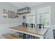 Open dining room features a wooden table, neutral paint, modern lighting, and windows with lots of natural light at 169 Forest Dr, Graham, NC 27253