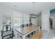 Bright dining area featuring a wooden table, bench seating, and modern lighting at 169 Forest Dr, Graham, NC 27253
