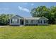 Charming single-story home featuring blue siding, black shutters, and a well-manicured lawn at 169 Forest Dr, Graham, NC 27253