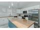 Bright kitchen with butcher block counters, white cabinets, stainless steel appliances and a center island at 169 Forest Dr, Graham, NC 27253
