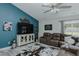 Stylish living room featuring blue accent wall, sectional sofa, and modern decor at 169 Forest Dr, Graham, NC 27253