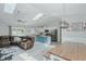 Open floor plan showcasing kitchen, dining room, and living area with leather sofa, skylights and modern finishes at 169 Forest Dr, Graham, NC 27253