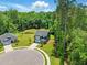 A high angle of a gray home on a cul-de-sac with a treeline in the background and expansive green lawn at 187 Harpers Landing Rd, Garner, NC 27529