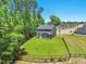 Spacious backyard, enclosed by a black fence, offers a safe play area and leads up to the house with screened porch at 187 Harpers Landing Rd, Garner, NC 27529