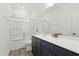 Well-lit bathroom with a shower-tub combination, white countertops and dark wood cabinets at 187 Harpers Landing Rd, Garner, NC 27529