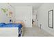 Bedroom with colorful decor, built-in storage, and neutral colored walls and flooring at 187 Harpers Landing Rd, Garner, NC 27529