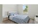Cozy bedroom with a patterned blue quilt, bright window, and neutral decor at 187 Harpers Landing Rd, Garner, NC 27529