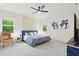 Stylish bedroom with a blue bed frame, patterned accent wall, and modern furnishings at 187 Harpers Landing Rd, Garner, NC 27529