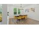 Bright dining room featuring stylish yellow chairs and attractive laminate flooring at 187 Harpers Landing Rd, Garner, NC 27529